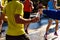 A helping hand delivers a bottle of water to a runner in a running race for him to drink