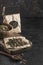 Hemp flakes in a coconut bowl for healthy food on a wooden Board on a black background