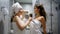 Hen-party, Girlfriends dance and sing in dryer as in microphone in shower
