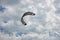 Henichesk, Ukraine - July 12, 2021: Kitesurfing. Practicing kitesurfing at summer beach. Kitesurfer doing tricks. People enjoy