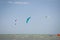 Henichesk, Ukraine - July 12, 2021: Kitesurfing. Seascape with kitesurfer in waves. Surfer in wetsuit doing trick in air against