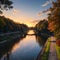 the Henley Street Bridge over the Tennessee River surrounded by autumn colored trees, lush green trees and office