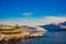 Henningsvaer, Norway - April 09, 2018: Above view of wooden buildings and fishing boats in the port of Henningsvaer in