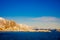 Henningsvaer, Norway - April 09, 2018: Beautiful above view of wooden buildings with huge mountaing behind in