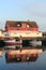 Henningsvaer red building and boats mirroring