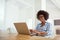 Her blog is trending online. a young woman working on her laptop at home.