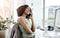 Her clients know how to reach her. a young businesswoman using a mobile phone at her desk in a modern office.