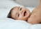 Her giggles are just the cutest. Portrait of an adorable baby girl lying on a bed at home.