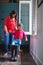 Her little girl gets bigger every day. Full length shot of a mother helping her daughter try on a pair of large rain