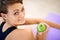 Her secret weapon to a healthy life. a sporty young woman sitting on a gym floor eating an apple.