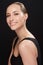 Her smile lights up every room. Studio portrait of an attractive young woman isolated on black.