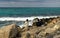 HERAKLION, GREECE - November, 2017: Tourists resting on the stones by the sea near old Venetian fortress, Heraklion port, Crete