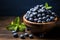 Herb adorned wooden bowl overflows with vibrant, fresh picked blueberries