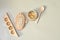 Herb in capsules in wooden bowl on pastel beige background. Beauty products for face and body skin care