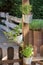 Herb pots with fresh culinary herbs attached to a wooden post