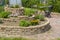 Herb spiral in the garden with herbs and flowers