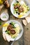 Herb turkey patties served with couscous and fresh salad