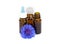 Herbal essential oil in glass bottles with blue organic flower