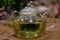 Herbal infusion with fresh mint leaves, in clear glass tea pot.