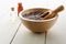 Herbal Lavender Buds in Wooden Bowl with Glass Bottles containing Oils on Wood Plank Table