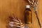 Herbal organic ubtan in glass bottle on wooden background with dried protea flowers, flat lay. Ubtan ayurveda. Plastic free