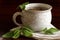 Herbal tea in a ceramic cup and salvia leaves on dark brown wood