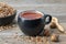 Herbal tea cup, healthy oak bark in ceramic bowl and acorns. Herbal medicine