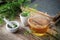 Herbal tea cup, shepherds purse, mortar and old book.