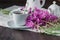 Herbal tea in a glass cup, fresh flowers fireweed against the da