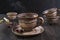 Herbal tea, herbs and flowers in a clay cup on wooden table