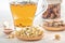 Herbal tea with pharmaceutical chamomile, dry chrysanthemum and hunters on a white table