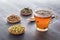 Herbal tea with pharmaceutical chamomile, dry chrysanthemum and hunters on  wooden table