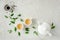 Herbal tea with two white tea cups and teapot, with green tea leaves. Flat lay, top view. Tea concept