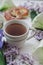 Herbal tea with wisteria, irises, white callas on gray background.