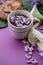 Herbal tea with wisteria, irises, white callas on violet background.