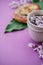 Herbal tea with wisteria, irises, white callas on violet background.