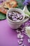 Herbal tea with wisteria, irises, white callas on violet background.