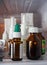 Herbal tincture vials, nosal sprays, eye drops and boxes on the refrigerator shelf close-up.