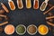 Herbs, spices and food additives on a dark background with an empty place