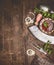 Herbs, spices and sauce with aged kitchen tools on rustic wooden background, top view, border. Country cuisine