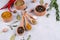 Herbs and spices selection in wooden spoons - rosemary, garlic, salt, pepper on gray table. Food flat lay.