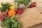 Herbs and vegetables with a blank chopping board