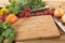 Herbs and vegetables with a blank chopping board