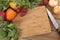 Herbs and vegetables with a blank chopping board. Space for copy