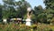 Hercules with globe in center of the garden, covered with little flower trees.