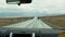 Herd of cattle cross road in front of driving cars in steppe