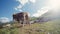 Herd of cows and a goat grazing and relaxing on an Alpine meadow, one of the Alpine cows tries to come closer to the