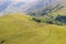 A herd of sheep grazes high in the mountains. Agriculture. Pasture in the mountains, jailoo. Kyrgyzstan