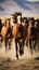 A herd of wild mustangs running across a desert landscape