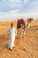 Herder with camel near the pyramids at Giza